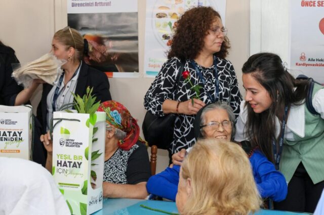foto.jpg Hatay Büyükşehir Belediyesi yetkilileri huzurevi sakinlerine çiçek ve fidan verirken